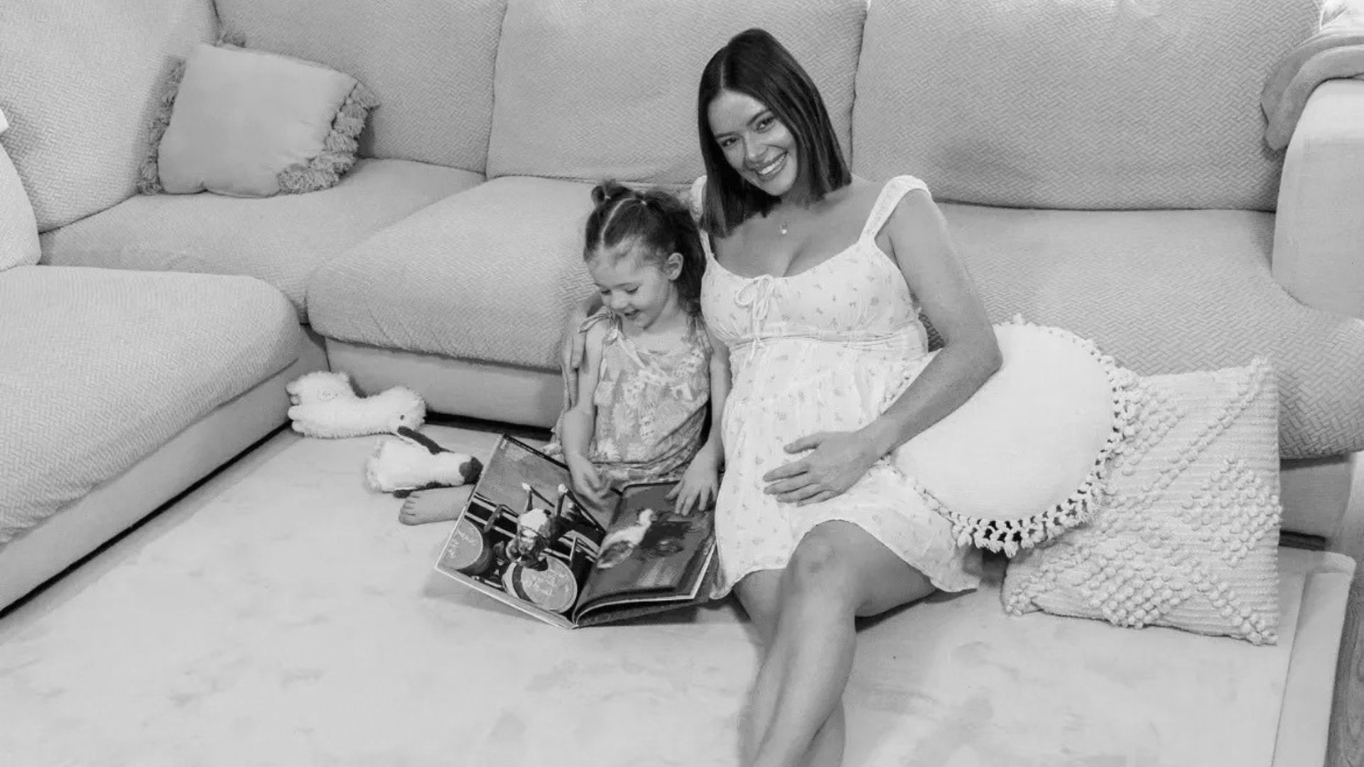 Mother and child relaxing on sofa with Muscle Mat comfort pillows and home living accessories